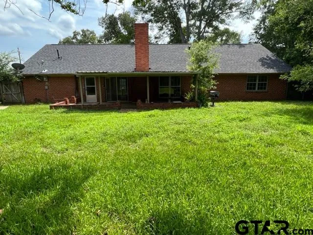 a front view of a house with a garden and yard