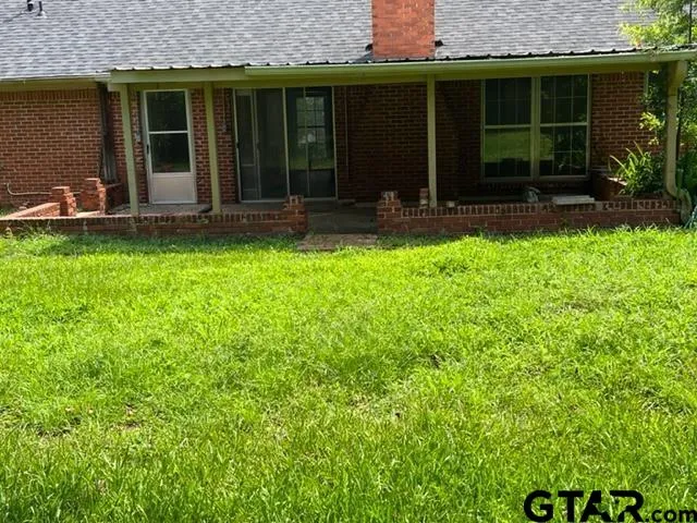 a view of house with yard and outdoor space