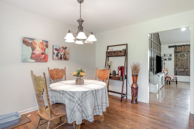 626 West Harper Road Portland, TN 37148 - Photo 19 of 26 a view of a dining room with furniture wooden floor and a chandelier