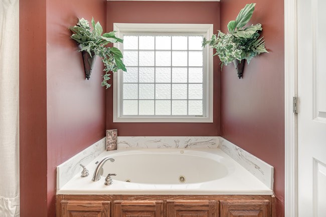 626 West Harper Road Portland, TN 37148 - Photo 5 of 26 a bath tub sitting in a bathroom next to a window