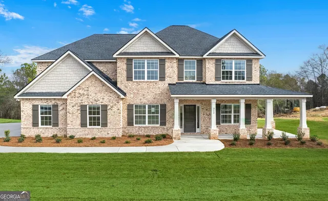 a front view of house with yard and green space