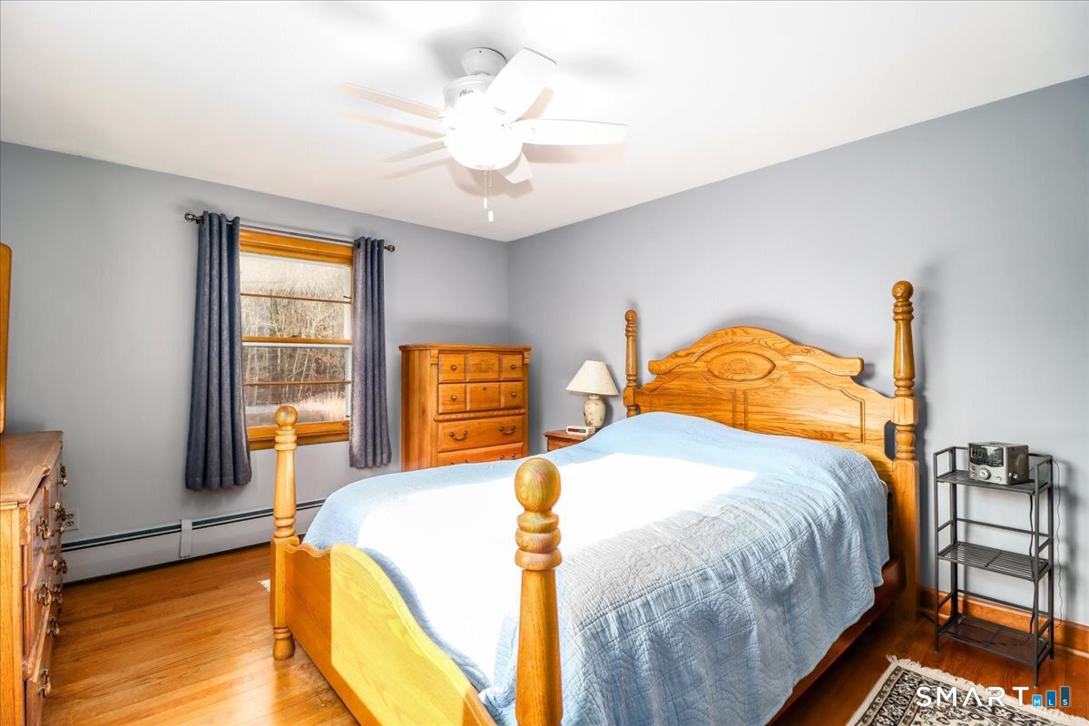 120 Warsaw Street Deep River, CT 06417 - Photo 14 of 39 a bedroom with a bed and a chandelier