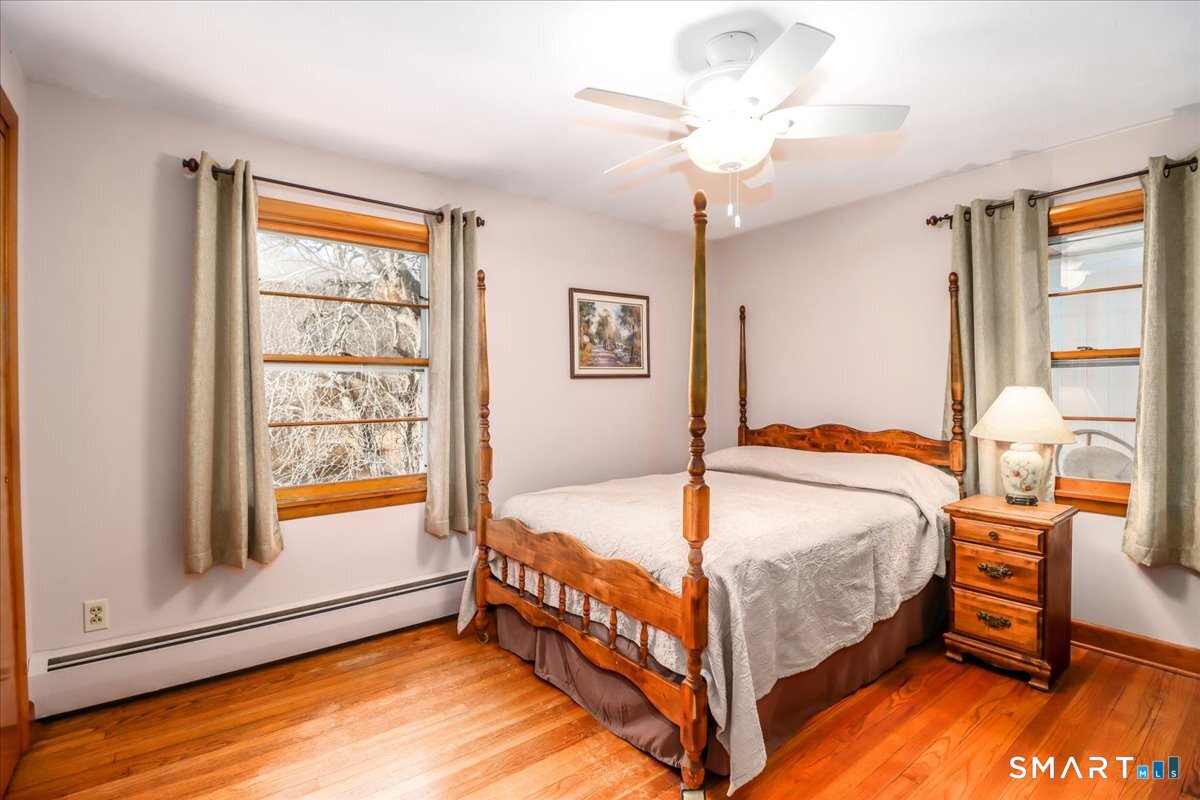 120 Warsaw Street Deep River, CT 06417 - Photo 16 of 39 a bed sitting in a bedroom next to a window