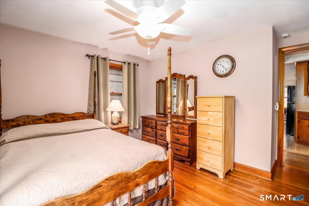 120 Warsaw Street Deep River, CT 06417 - Photo 17 of 39 a bedroom with a large bed and a chandelier