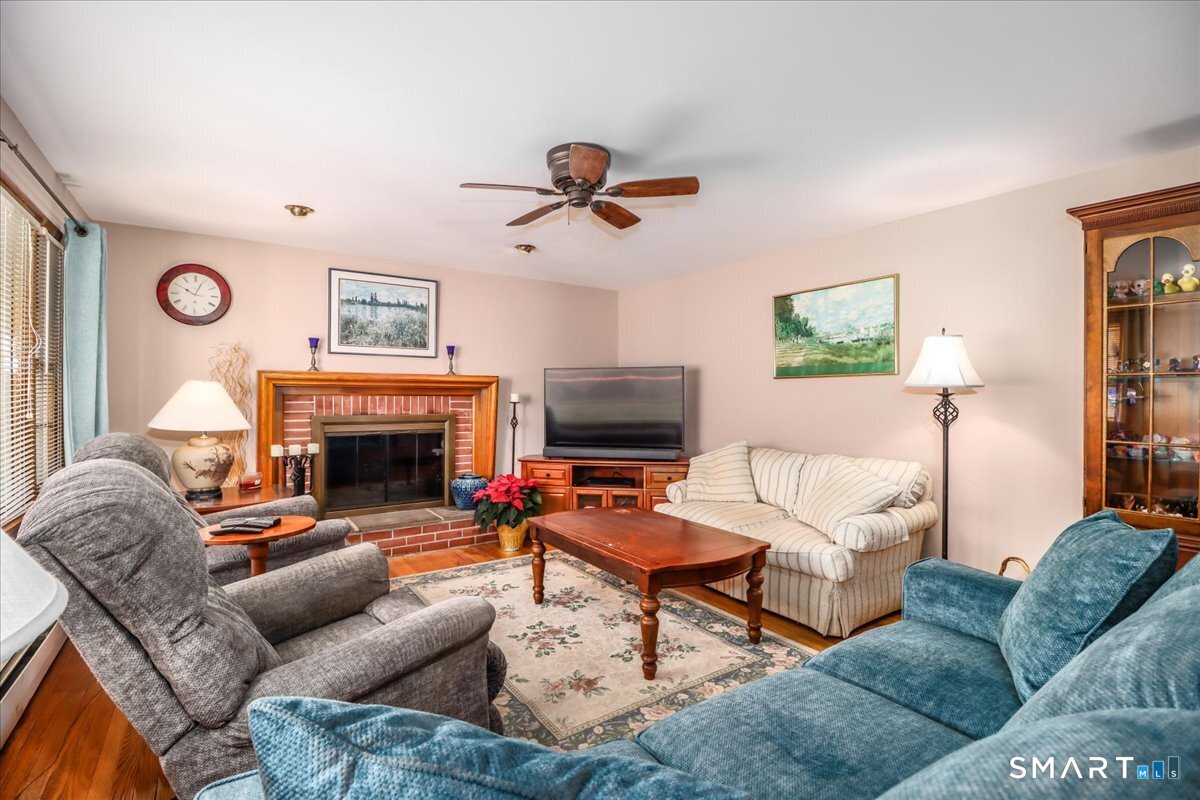 120 Warsaw Street Deep River, CT 06417 - Photo 5 of 39 a living room with furniture a fireplace and a flat screen tv