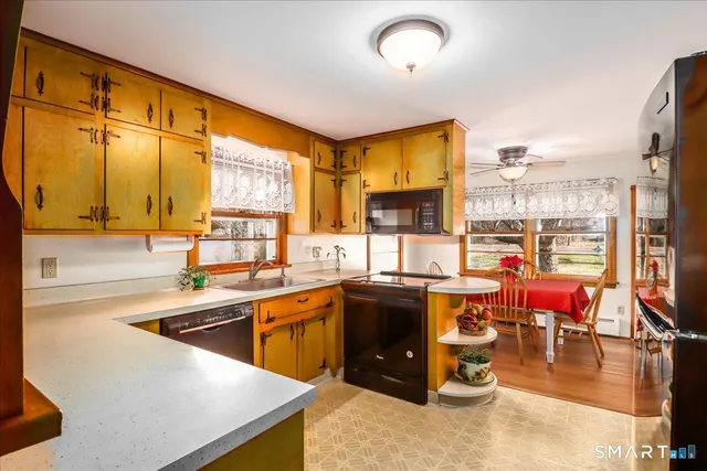 a kitchen with lots of counter top space and dining table