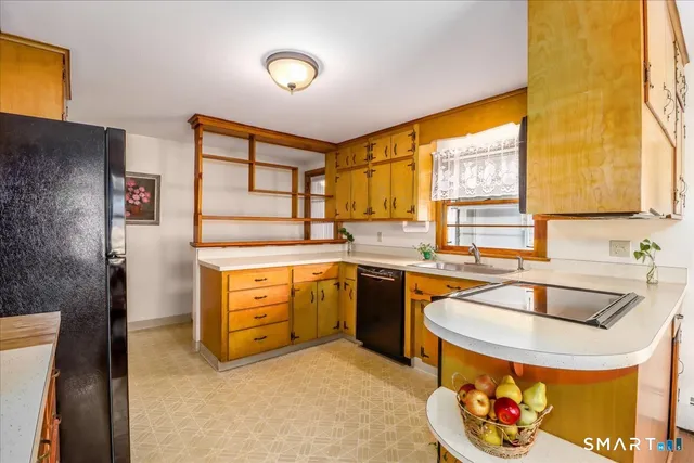 a kitchen with stainless steel appliances granite countertop a sink and a stove