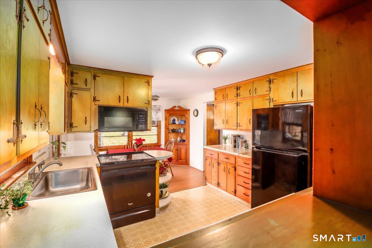 120 Warsaw Street Deep River, CT 06417 - Photo 10 of 39 a kitchen with stainless steel appliances kitchen island granite countertop a refrigerator and a stove