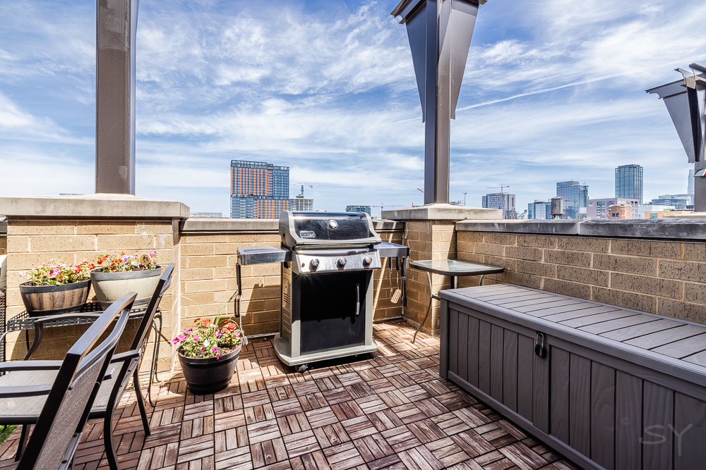 1301 West Madison Street, Unit 607 Chicago, IL 60607 - Photo 30 of 39 a view of a balcony with wooden floor and barbeque grill