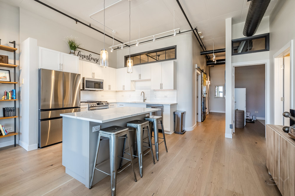 1301 West Madison Street, Unit 607 Chicago, IL 60607 - Photo 8 of 39 a kitchen with stainless steel appliances a stove a refrigerator and a refrigerator