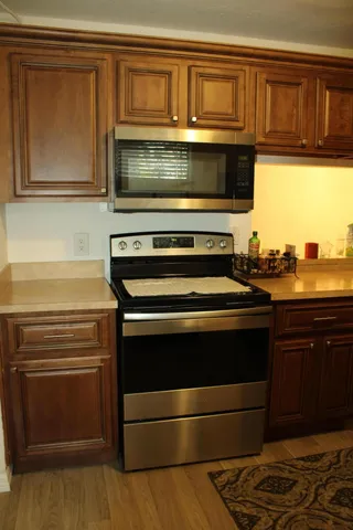 a kitchen with granite countertop a stove and a microwave