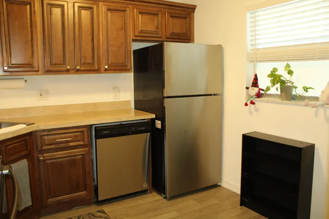 a white refrigerator freezer and a stove sitting inside of a kitchen