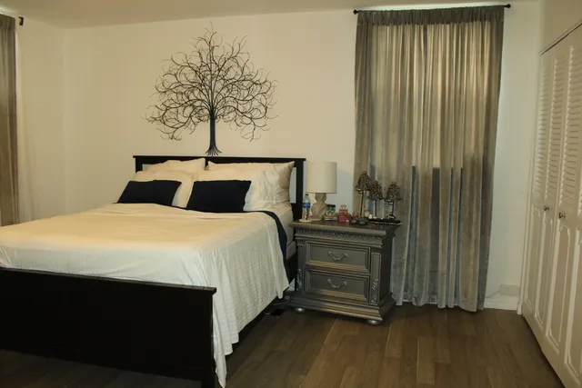 a bedroom with a bed and a window