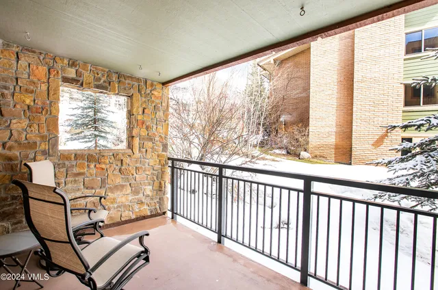 a view of a room with wooden floor and windows