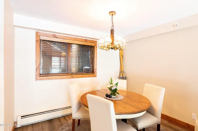 a view of a dining room with furniture and chandelier