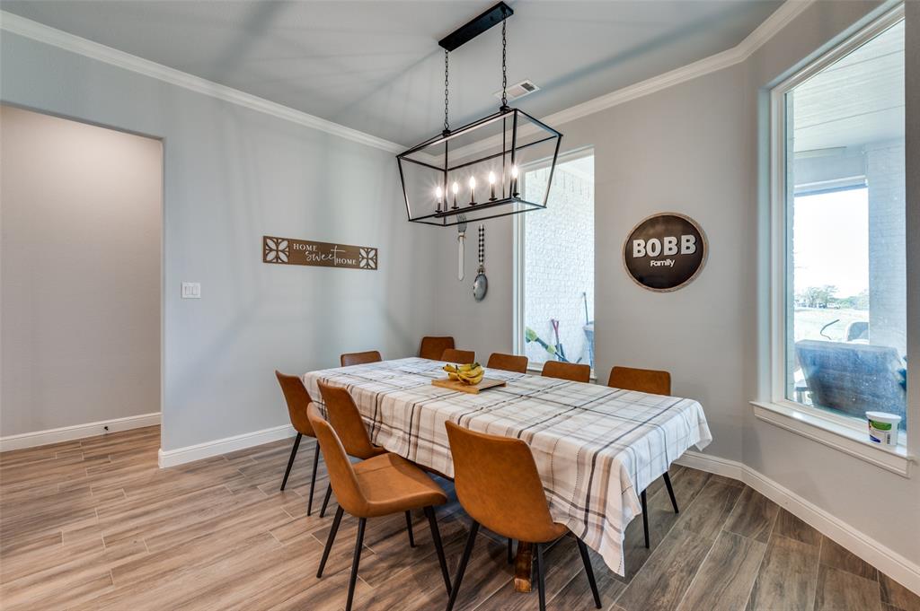 131 San Miguel Drive Decatur, TX 76234 - Photo 16 of 40 a dining room with a wooden table and chairs
