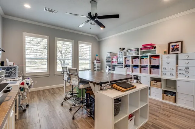 a kitchen with stainless steel appliances a stove a table and a chandelier