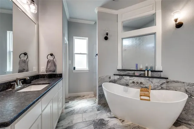 a bath tub sitting in a bathroom and mirror