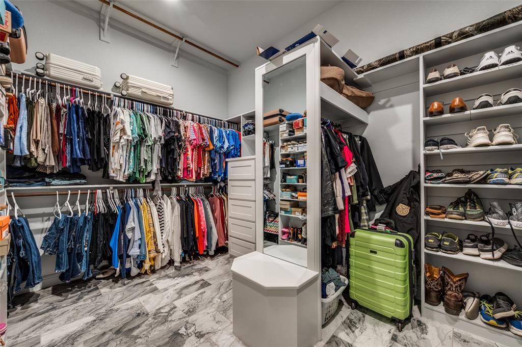 131 San Miguel Drive Decatur, TX 76234 - Photo 27 of 40 a view of walk in closet with clothes and shoes