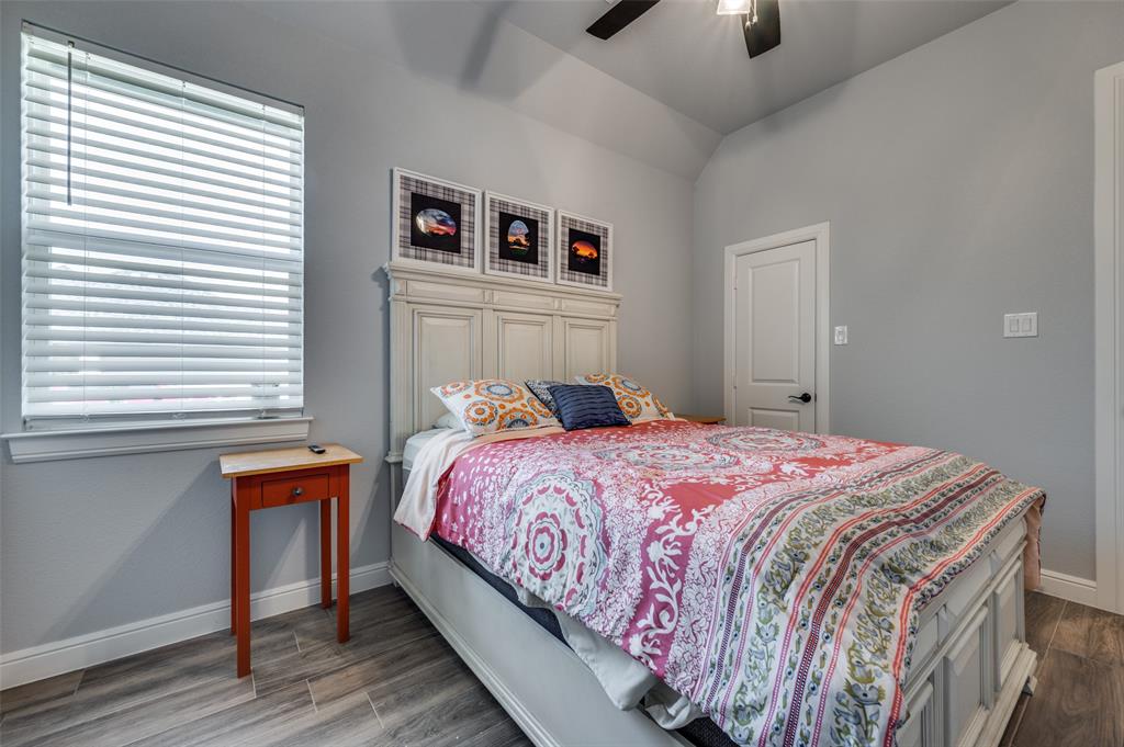 131 San Miguel Drive Decatur, TX 76234 - Photo 30 of 40 a bedroom with a bed and a chandelier