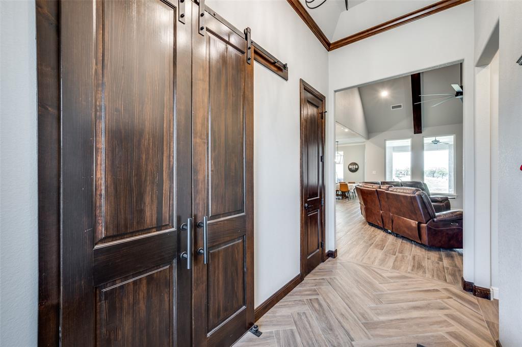 131 San Miguel Drive Decatur, TX 76234 - Photo 3 of 40 a view of a hallway with a couch and wooden floor