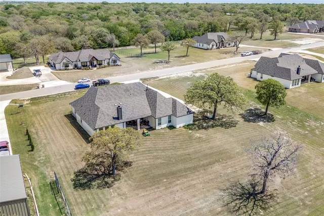 an aerial view of a house with swimming pool