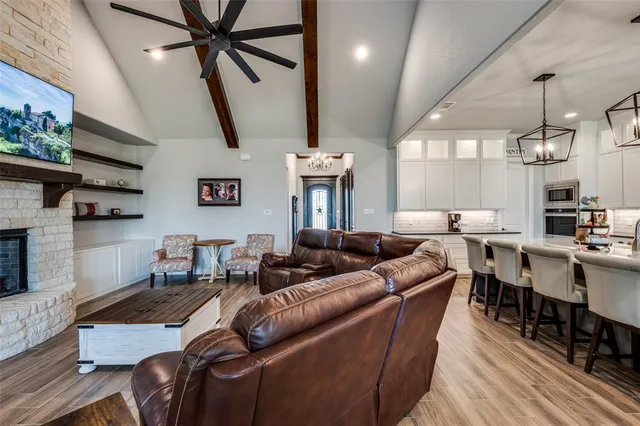 a living room with furniture a fireplace and a flat screen tv