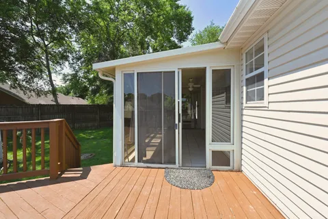a view of backyard with a deck and wooden floor