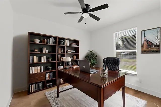 a living room with furniture and a book shelf