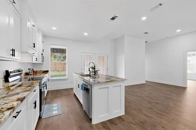 a kitchen with stainless steel appliances a stove top oven