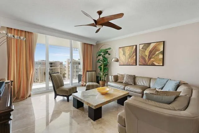 a living room with furniture and kitchen view