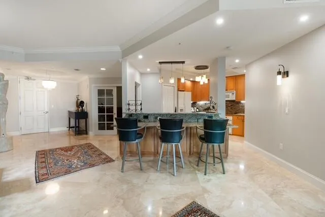 a kitchen with stainless steel appliances kitchen island granite countertop a sink and cabinets