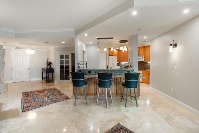 230 Ocean Grande Boulevard, Unit 802 Jupiter, FL 33477 - Photo 17 of 42 a dining hall with stainless steel appliances lots of white furniture a dining table and chairs