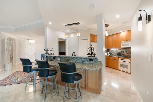 230 Ocean Grande Boulevard, Unit 802 Jupiter, FL 33477 - Photo 19 of 42 a kitchen with stainless steel appliances kitchen island granite countertop a sink and cabinets