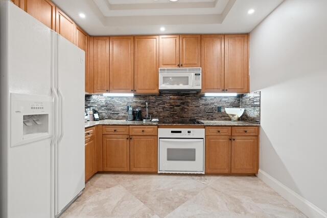 230 Ocean Grande Boulevard, Unit 802 Jupiter, FL 33477 - Photo 21 of 42 a kitchen with stainless steel appliances granite countertop a stove a sink and a refrigerator
