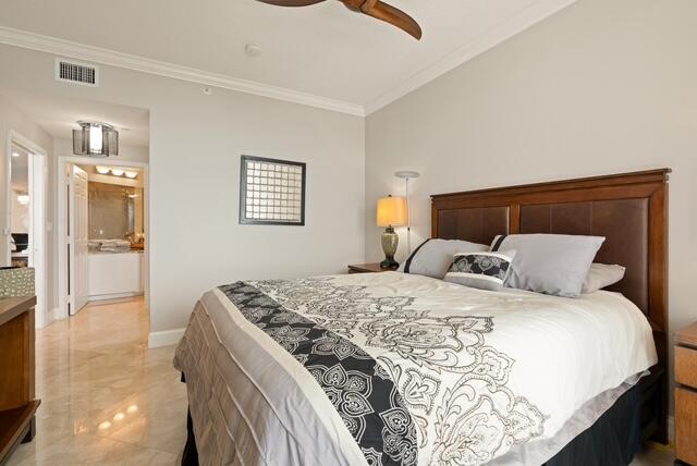 230 Ocean Grande Boulevard, Unit 802 Jupiter, FL 33477 - Photo 32 of 42 a bedroom with a large bed and a chandelier