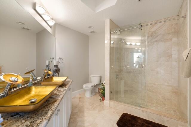 230 Ocean Grande Boulevard, Unit 802 Jupiter, FL 33477 - Photo 34 of 42 a bathroom with a granite countertop sink a mirror and a shower