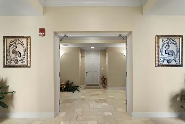 a view of a hallway with paintings on the wall