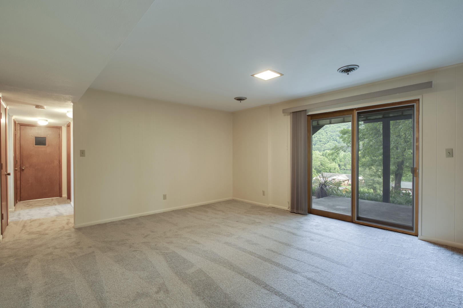 517 Gibbs Ferry Road Clinton, TN 37716 - Photo 29 of 36 a view of an empty room with wooden floor and a window