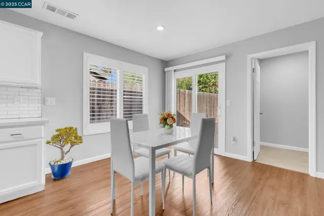 a view of a dining room with furniture and a potted plant