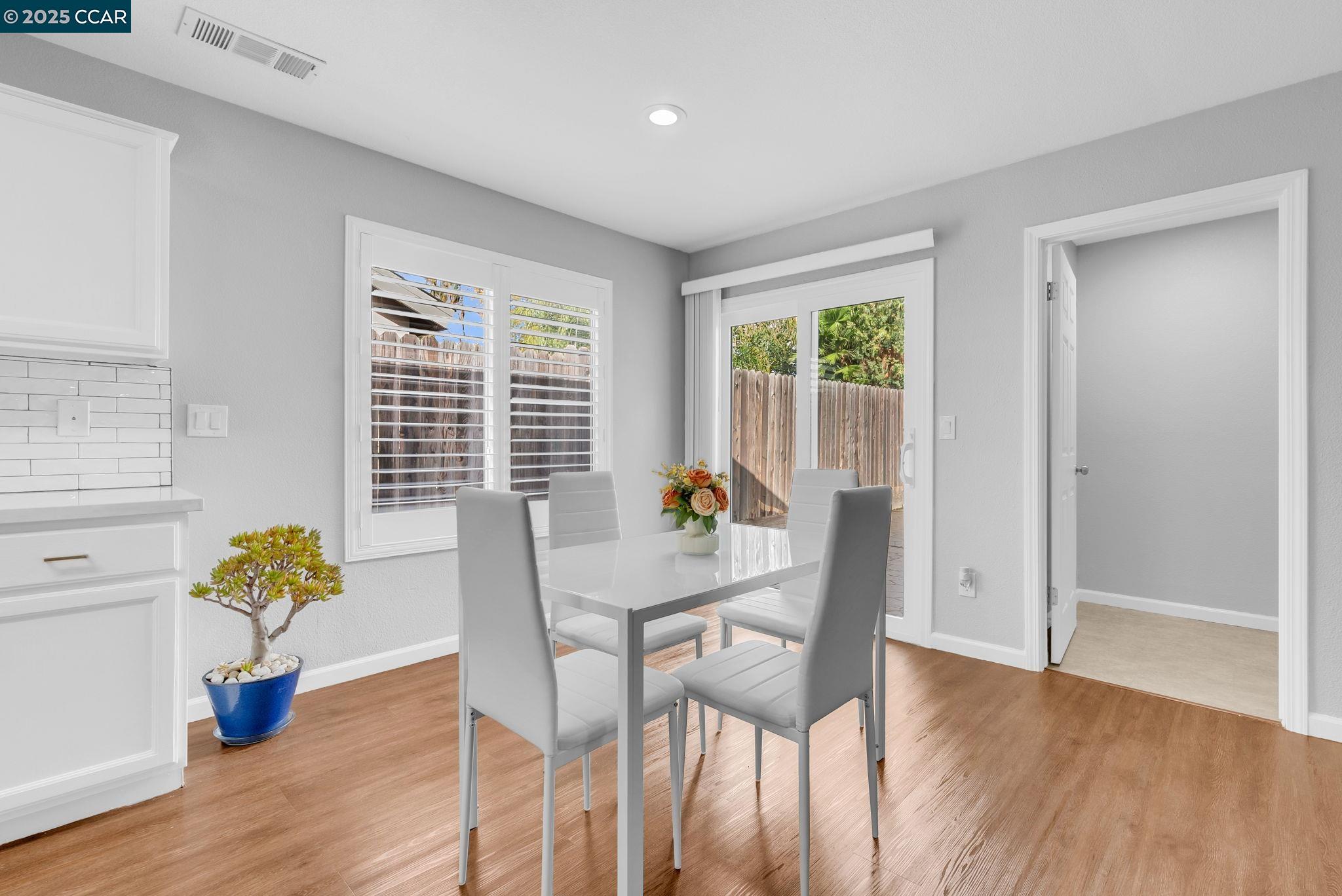 432 Red Robin Drive Patterson, CA 95363 - Photo 16 of 47 a view of a dining room with furniture and a potted plant