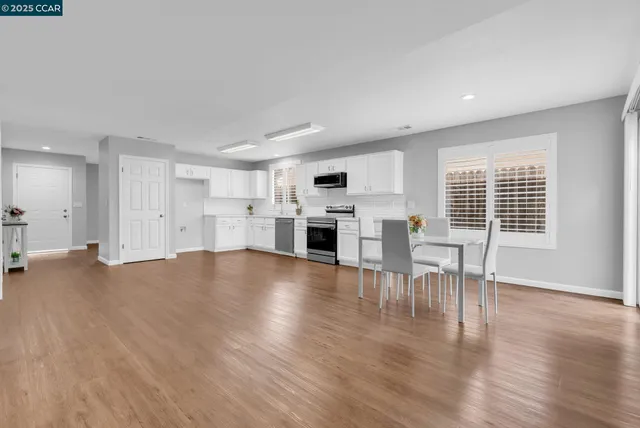 a view of kitchen with furniture and wooden floor