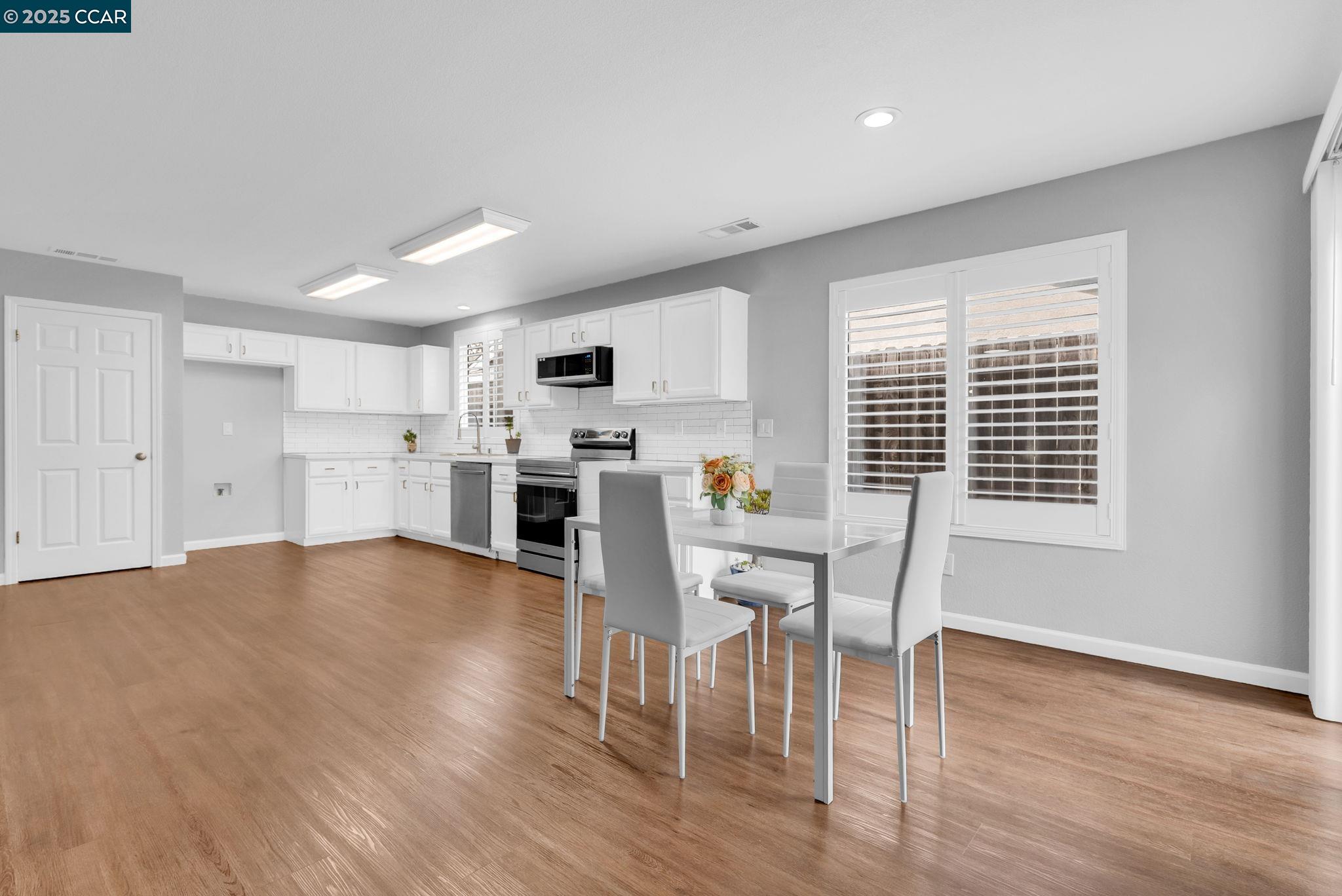 432 Red Robin Drive Patterson, CA 95363 - Photo 20 of 47 a view of a kitchen with microwave and furniture