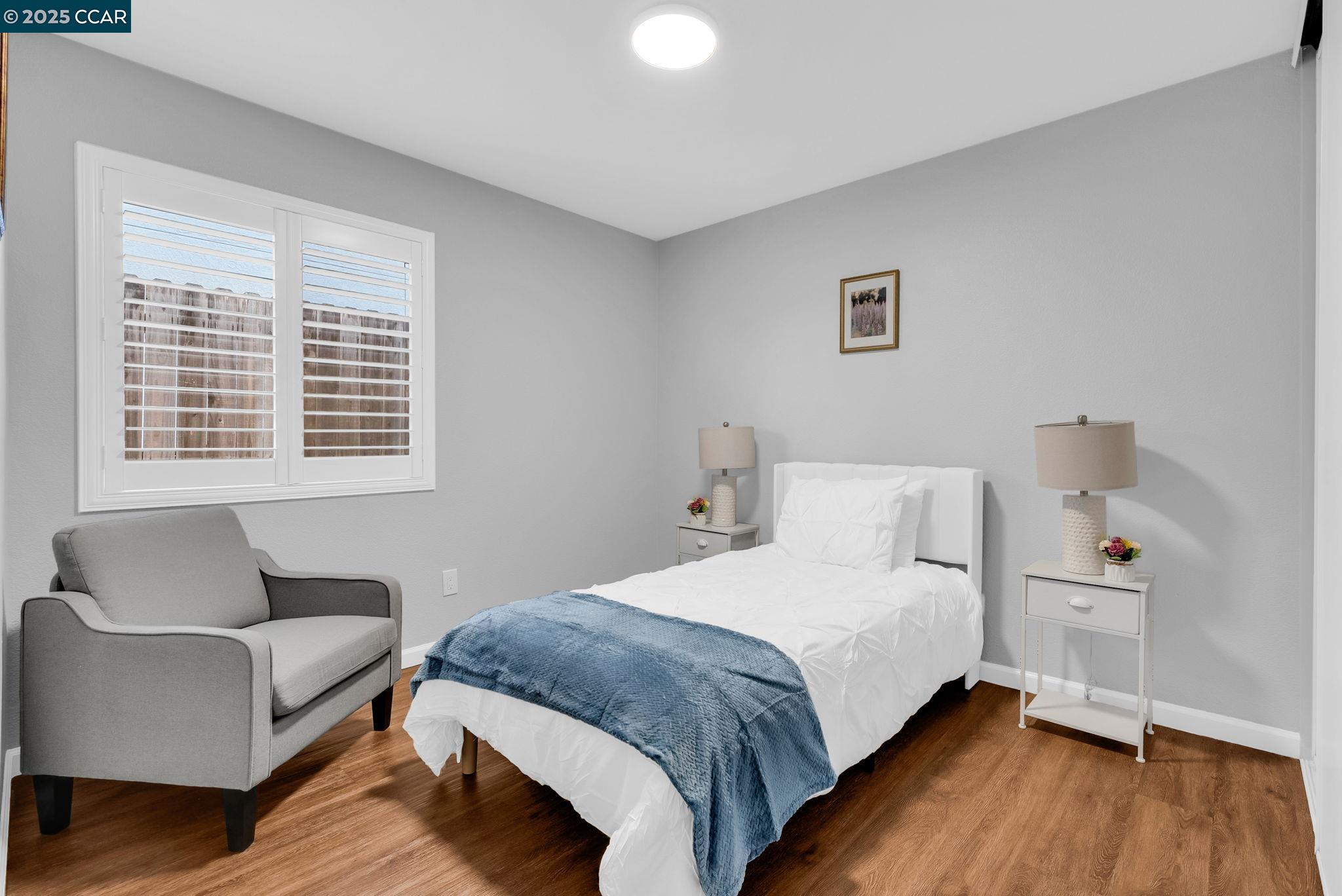 432 Red Robin Drive Patterson, CA 95363 - Photo 22 of 47 a bedroom with a bed couch and a window