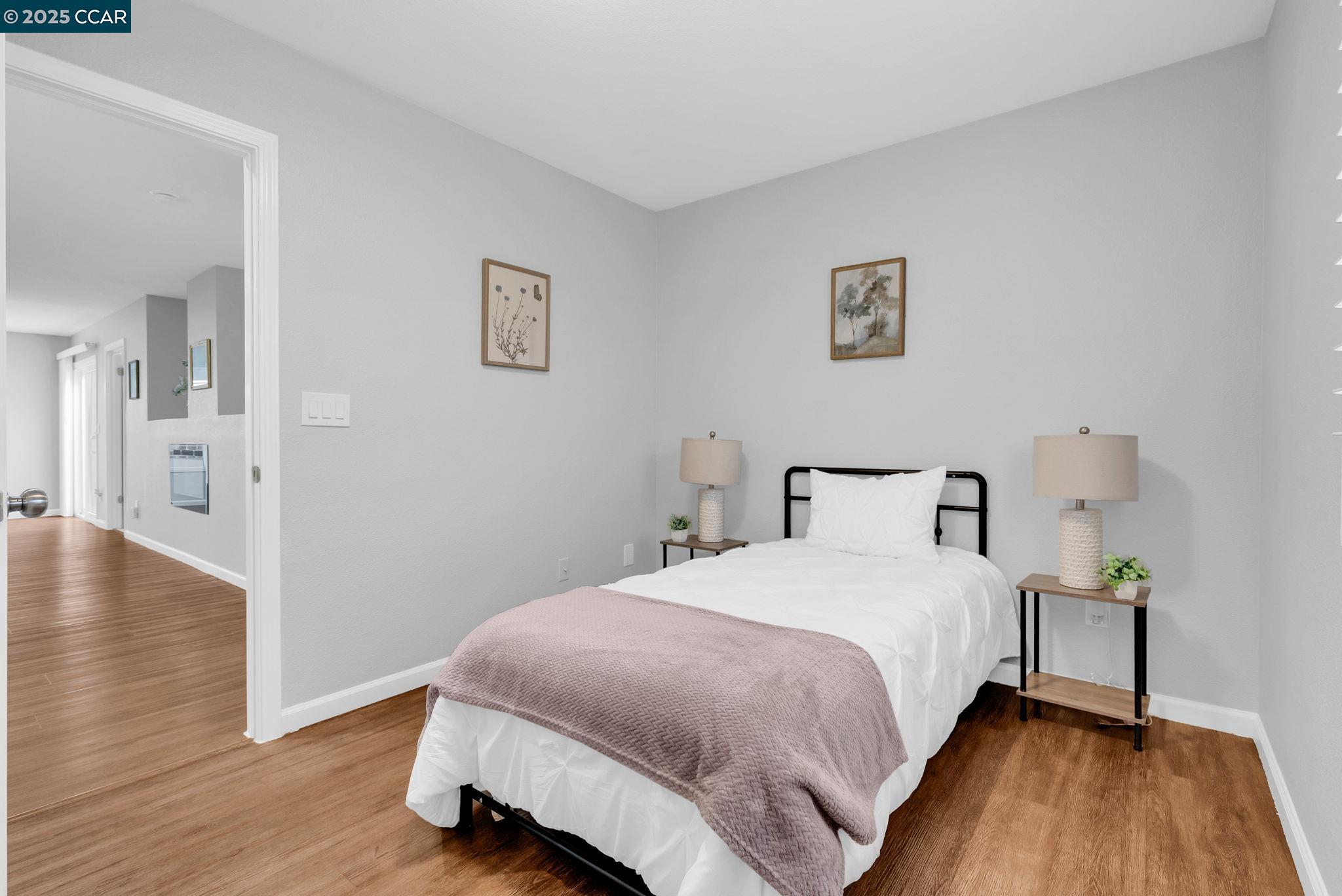 432 Red Robin Drive Patterson, CA 95363 - Photo 26 of 47 a bedroom with a bed and wooden floor