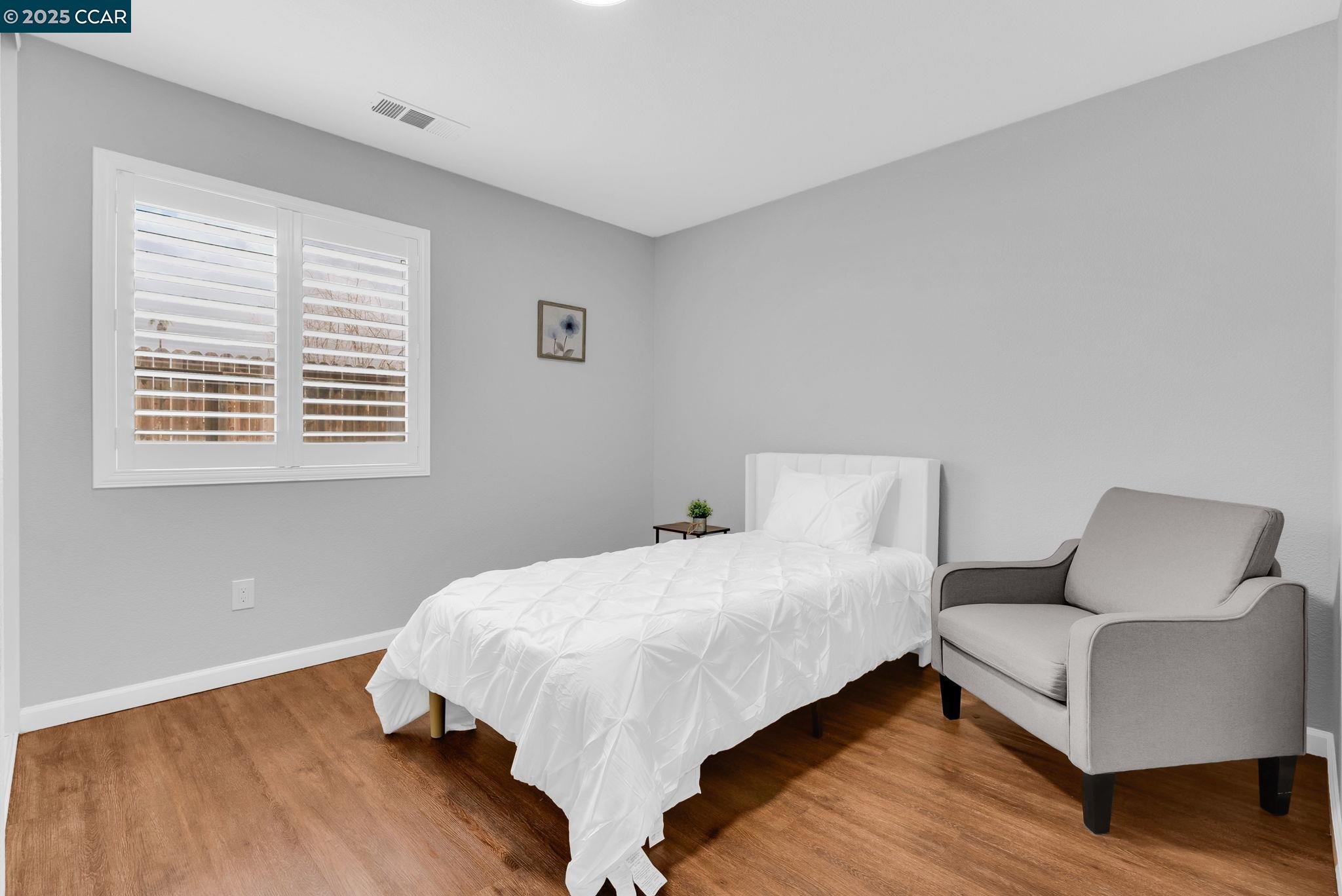 432 Red Robin Drive Patterson, CA 95363 - Photo 30 of 47 a bedroom with a bed and a couch