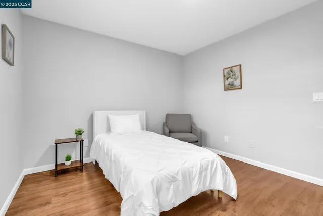 a bedroom with a bed and a night stand