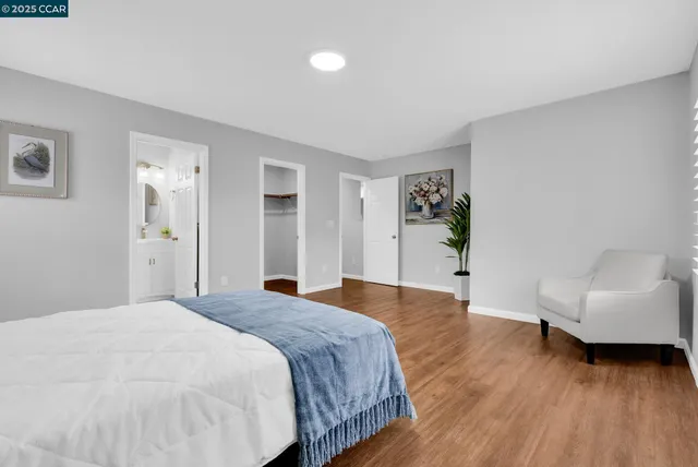 a spacious bedroom with a bed and a couch