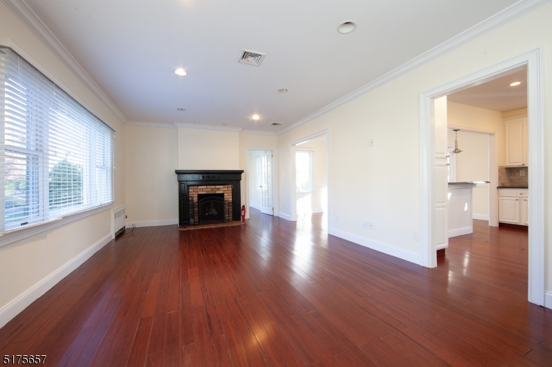 16 Columbus Avenue Glen Ridge, NJ 07028 - Photo 10 of 14 a view of a livingroom with wooden floor and a fireplace