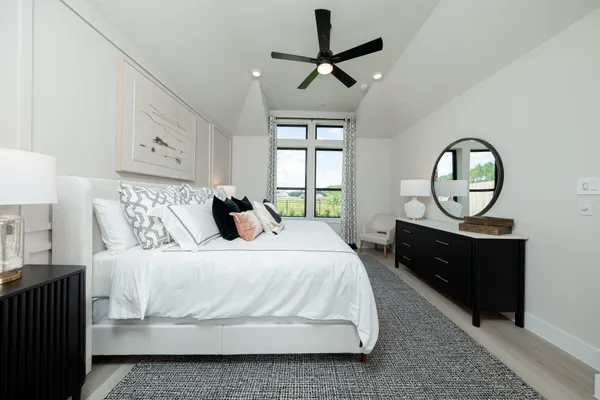 a spacious bathroom with a double vanity sink a large mirror a shower and bathtub